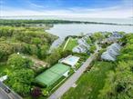 Lovely light-filled 3-bedroom 3 bath inland end-unit in The Cove â€“ a small hidden gem of a waterfront community nestled in the heart of the North Fork. There are boat slips for your boat with easy access to the beautiful Peconic Bay, boat racks for your paddleboard/kayak, a gunite in-ground pool, and combination tennis/pickleball court â€“ both of which were just resurfaced this year! The airy open concept living room and dining room share a wood burning fireplace and there is a balcony off the living room. The kitchen has granite counters and sliding glass doors to the deck and the backyard. Also on the first floor is a spacious primary bedroom suite with sliders to the deck and a large ensuite bathroom. The 2nd level has two more generous bedrooms, a library/media room, and full bath. There is storage galore in the finished basement with a separate laundry area, and a one-car garage. The entire community is presently in the process of being re-shingled with handsome grey Hardi-shingles and white trim. Beaches, wineries, farms, breweries, golf, & hamlet shopping, dining, and transportation just moments away! A perfect, maintenance-free Retreat!