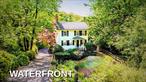 Welcome to 80 E Broadway, where storybook charm meets timeless elegance in the heart of historic Roslyn. Tucked between two tranquil pondsâ€”one gracing the front of the property and the other offering direct shoreline access to the famed Roslyn Duck Pondâ€”this enchanting residence is a rare opportunity to own a true piece of Long Island history. From the moment you arrive, you&rsquo;re transported: a private lily pond sets the tone, evoking the ambiance of a secluded European garden, while lush landscaping frames the home like a scene from a fairytale.Spanning three levels, this historic gem is rich with original character: exposed beams, period moldings, gleaming hardwood floors, and three cozy fireplaces adding warmth and charm throughout. Oversized windows and double doors on both the main and lower levels frame stunning pond views and invite natural light to dance across every room.Though intimate in size, the home lives large with thoughtfully designed spaces perfect for both relaxing and entertaining. From sunrise coffees by the waterâ€™s edge to fireside evenings with friends, every moment here feels intentional, romantic, and serene.Located just steps from Roslynâ€™s vibrant village centerâ€”with its boutique shops, award-winning restaurants, parks, museums, and the nearby LIRRâ€”this home offers a seamless blend of nature, history, and convenience.80 E Broadway isnâ€™t just a homeâ€”itâ€™s a retreat, a legacy, a lifestyle. This is Roslyn at its most magical.