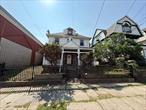 Nestled in the heart of vibrant downtown Yonkers, this commanding white Colonial offers a rare opportunity to own a piece of vintage charm with endless potential. Boasting spacious rooms, soaring ceilings, and a timeless formal floorplan, the home welcomes you with an expansive living room perfect for entertaining, a gracious formal dining room, a bright white kitchen filled with natural light, a dedicated office space, and a convenient powder roomâ€”all on the main level. The upper two floors offer five delightful bedrooms and two full bathrooms, providing ample space for comfortable living or creative reimagining. A full unfinished basement presents a blank canvas for future expansion, whether you dream of a media room, gym, or workshop. Outside, enjoy summer days on the lovely covered front porch or host gatherings on the oversized concrete patio in the private backyard. While the home still needs work, its solid bones, classic features, and unbeatable location make it a unique opportunity for those with vision. Just steps from the Yonkers waterfront, award-winning restaurants, shops, parks, the Hudson River Museum, and Metro-North for a quick commute to NYC, this home offers both charm and convenience in one of Westchesterâ€™s most exciting neighborhoods.