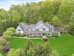 Welcome to this exceptional home where luxury and functionality meet. A bluestone walkway leads to a covered front porch with built-in heaters, setting the stage for refined living. Inside, a grand foyer opens to thoughtfully designed living spaces. The gourmet kitchen features an oversized island, 6-burner Wolf oven, Sub-Zero refrigerator and freezer, dual dishwashers, and a spacious walk-in pantry. A formal dining room with an adjacent butlerâ€™s area and sink makes entertaining seamless. The family room boasts coffered ceilings and a dual-sided wood-burning fireplace, opening through French doors to a covered outdoor sitting area. A formal living room and sunroom overlook mature landscaping, offering peaceful retreats. Additional highlights include a mudroom with built-in storage, laundry room, and access to a 4-bay garage, all designed for comfort and convenience. Upstairs, retreat to the luxurious Primary Suite features a gas fireplace and two sets of French doors leading to a spacious private deck overlooking the backyard. The spa-inspired primary bath includes a soaking tub, walk-in shower, double vanity, private water closet, and dual expansive walk-in closets rooms with custom built-ins. Three additional en-suite bedrooms offer high ceilings and walk-in closets, providing comfort and privacy for all. A generous bonus room with its own powder room and a second laundry area completes the upper level, offering flexibility for recreation, work, or guest space. An entertainerâ€™s dream awaits on the lower level, featuring a spacious recreation area with a wet bar and sink, a dedicated movie room with theater seating, and a fitness room complete with a sauna, steam room, and spa area for ultimate relaxation. A powder room adds convenience, while a fifth en-suite bedroom provides a private retreat for guests or extended family. The outdoor living space boasts an in-ground pool, built-in BBQ, and professionally landscaped gardens with custom lighting, offering a stunning backdrop for both relaxation and entertaining.