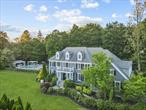 This meticulously designed Colonial in the prestigious Chappaqua Central School District provides a true haven for those who appreciate refined living with a contemporary turnkey design aesthetic. The blend of traditional and contemporary vibes creates an exquisite mix of sophistication and relaxed comfort for entertaining and everyday living. Featuring high-end finishes throughout, every level of this stunning home has been thoughtfully upgraded. At the heart of the home, an inviting great room showcases a floor-to-ceiling stone fireplace flanked by dramatic picture windows that showcase the gardens beyond, providing a front row seat to the magnificent color of the changing seasons. This room seamlessly connects to an updated gourmet kitchen with an oversized island and wine storage plus ample seating perfect for gathering and entertaining. The thoughtfully considered coffee bar and beverage center make mornings a pleasure. The custom library with floor-to-ceiling oak shelving, built-in cocktail bar, and additional picture windows looks out over the expansive grounds and hand-stacked stone wall, onto the shimmering pool beyond. This library space leads to a private office, while the elegant dining room with wainscoting provides an ideal setting for both intimate dinners and larger celebrations. The grand foyer presents a double high space with a graceful curved front staircase leading to the second-floor Primary Suite, where custom backlit molding and built-in oak shelving add warmth and sophistication. The Waterworks spa-like master bath features radiant heated floors and abundant natural light. A second en-suite bedroom offers privacy for guests, while two additional bedrooms are connected by a stylish full bath with heated floors, no-step shower, and under-cabinet lighting. At the end of the long hall, a bright and spacious bonus room with custom built-in cabinets offers endless possibilities, with a back staircase leading from the bedrooms to the mud room with custom cubbies, shelving and side door. The walk-up third floor boasts expansive finished storage illuminated by natural light. Meanwhile, the incredible lower level is a suite unto itself, designed for versatility: featuring a large, bright art studio; stylish room with custom-designed sliding doors for versatile usage; barn doors leading to deep storage space; a state-of-the-art workout area; yoga studio; and a home theater/game room/lively entertainment space. Step outside to a backyard paradise, where a stone patio opens onto a resort-style oasis including a heated gunite pool and spa surrounded by lush mature and meticulously planned landscaping, creating a private retreat for every season of the year. A luxurious cabana with Wi-Fi, whole home sound system and outdoor TV provides a shaded lounge area, perfect for unwinding poolside. The fully equipped outdoor kitchen makes al fresco dining effortless for large parties or small gatherings. Enjoy fresh vegetables from your very own organic garden. A true sanctuary in every way, every detail of this extraordinary home has been curated to offer timeless elegance and modern convenience for a contemporary lifestyle.