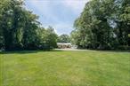 Unmatched value! This 3, 300 SF (4 bedroom, 3-bath) home sits on a commanding 2.55 acre hilltop site, with 360-degree privacy that enhances the estate-type grounds off a quiet cul-de-sac. Enjoy seasonal harbor views through the treesâ€”or add a second story for year-round harbor vistas. A rare find at this price combines luxury, privacy, on one of the best multi-acre sites in all of Cold Spring Harbor. A grand welcoming entrance drive leads to this well-sited home that boasts a sunlit living room with hardwood floors and oversized windows showcasing sweeping serene, bucolic views in a park-like setting. The main level features a primary en-suite, a guest bedroom, and a versatile office/den that could easily become an additional fifth bedroom. The spacious eat-in kitchen opens to a covered porch - perfect for seamless indoor/outdoor entertaining. At garden level, discover two more bedrooms, a luxurious marble bath, and a sprawling entertainment room, ideal for movie nights or hosting guests. Conveniently located near the Cold Spring Harbor Train Station (5 minutes away), Jerico Turnpike and LIE, moments from Eagle Dock Beach (dues required), local state park trails and located in the top-ranked Cold Spring Harbor School District #2.