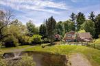 Set on beautifully landscaped grounds, this 4-bedroom, 3.5-bath home delivers all the private getaway vibes with a natural spring-fed pond, perennial gardens, a heated gunite pool.Inside, youâ€™ll find a layout thatâ€™s as functional as it is stunningâ€”anchored by a soaring Great Room with 20-foot ceilings and a wood-burning stove that begs for cozy evenings and good company. The chefâ€™s kitchen flows seamlessly into a generous dining room with its own fireplace, making hosting a breeze. Need a private guest or in-law setup? A first-floor bedroom with its own entrance, full bath, and laundry has you covered. The upstairs primary suite is a true sanctuary, complete with an en suite bath and serene views of the property.Thereâ€™s more to love: a finished walk-out basement with loads of storage and flex space, multiple indoor and outdoor gathering areas, and an overall layout that works just as well for full-time living as it does for weekend escape artistry. Lounge by the pool, paddle across your own pond, or simply unwind surrounded by natureâ€™s best.All of this, just minutes to the Brewster Metro-North station (hello, easy NYC commute!) and 50 miles north of the George Washington Bridge. You&rsquo;re also close to local favorites like Purdyâ€™s Farmer & the Fish, the Brewster Ice Arena, Thunder Ridge for skiing, Run Free Farm for the equestrians, plus Danbury, CT for Whole Foods, Trader Joeâ€™s, and everything in between.