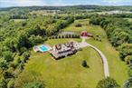 Rare Treasure! Incomparable, private, extraordinary, 46+ acre mini estate. 14 room, 6 bedroom, 3 bath colonial with panoramic vistas, 2 stocked ponds, 5 stall barn with water and electric, guest cottage with a professional kitchen, paddocks, run in sheds, wine cellar, in ground salt water pool & cabana with lav., basketball & pickleball, trails, fields, nature, trees, wildlife and much more. Just minutes to historic Village of Goshen, Route 17, & access to Heritage hiking & running trail. Your own private paradise to experience the beauty of nature, farm, ride horses or a possible subdivision with municipal water, sewer & gas now available at beginning of driveway. Great for destination weddings, events, catering, and bed and breakfast. Quality craftsmanship abounds in this manor with formal moldings, hardwood floors, 3 brick fireplaces & chef&rsquo;s designer kitchen, in-law quarters & much more. Close to major shopping, Route 17, Legoland, historic Village of Goshen amenities in one of the countyâ€™s hottest locations. One of a kind property that uplifts your spirits and has endless possibilities.