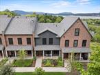 River Ridge Views is Beaconâ€™s most luxurious townhome community with western (sunset) views of the Hudson River & Newburgh-Beacon Bridge from your own private balcony made with Ipe Brazilian wood. The location of this community is walking distance to NYC express trains at Beacon and artsy Main Street, Beacon. This exclusive single family attached townhome is sure to please the most discriminating buyer, a magnificent home enriched with solid dove-tail wood cabinets, granite counters, farm sink, 42â€ cabinets, Bosch stainless appliances, mahogany front door, maple flooring, exposed barn-sized beams & steps, vaulted ceilings, enriched door trim, custom California closets, loft, pull down stairs, oversized 2 car garage with EV charger with possibilities for future development for in-laws. This spacious home is currently used as a 3 bedroom, 2.5 bath with an additional room on the main level which could be used as a dining room, art studio, office, music room, library, yoga, or 4th bedroom. The grounds are magnificent and clean. Professional landscaped with hundreds of perennials throughout the property, accented with a 200-year-old restored stone gazabo boasting with Hudson River Views and great sunsets.