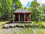 Welcome to this incredible 24.21-acre lot featuring panoramic views of Lake George from the high point of the property. This unique lot includes a well-maintained tiny home cabin built in 2010. Lot features over $20k+ in site clearing which has been completed at the top, creating an ideal building site with sweeping 100-mile views into Vermont. A private access road leads to the summit, offering easy entry to this secluded paradise. The property boasts a mix of open space and diverse forestry, providing both natural beauty and privacy. Located just minutes from Rogers Rock Campground, Hague Beach & Boat Launch, Bolton Landing, Diamond Point, Ticonderoga and much more. Endless opportunities to use as a year round retreat, Airbnb, or simply build your dream vacation home.