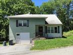 This well-maintained split level house has 4 spacious bedrooms, 2 full baths, + a A half bath. a nice dining room and eat-in kitchen, with a lot of closet space. From the driveway, you walk up a few stairs to the front porch, where you have the main door. Entering the front door into the hallway, to the left, thereâ€™s a coat closet, to the right of the hallway thereâ€™s a huge dining room, which opens up to the spacious nice eat-in kitchen, which leads you to the deck. Further down the main hallway to the left, you walk down a few stairs to the garage level where there is a nice comfortable bedroom. (From that bedroom you have access to the garage.) Another set of stairs take you to the second level, where you find the 2nd full bathroom and 2 more bedrooms one of them the master bedroom which has its own bathroom with Shower w/ closets. To the right of that hallway, next to that 3rd bedroom, there are a few more stairs going up to the 4th bedroom with a walk-in closet. And private bathroom. The house is very well-maintained inside out. Has a big garage plus a cellar with windows, together they add additional approximately 785 sq.ft. Property has nice grounds and a wide 2 car driveway. The property is a few minutes walking distance from the main shopping area on Broadway.