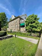 Timeless Elegance for Exceptional Living in this Expansive Home crafted by Italian Stone Masons in 1910, previously known as the Porter House Inn in the Heart of Millbrook Village.This imposing 4, 000 sf home lives even larger with a walk-up windowed attic on the third floor and full walk-out basement below, and further still with gracious covered porches on the front of the house and overlooking the private garden in the back. The inviting front porch welcomes you to a generous entry and stair hall, flanked by spacious rooms bathed in natural light from expansive windows with gleaming hardwood floors throughout. On one side is the grand living room and a well-appointed office suite with half bath, which opens to the garden, creating a peaceful retreat. Across the hall, the dining and reception room are ideal for hosting guests. Across the back of the home, the gourmet kitchen and dining area impresses with marble counters, a Bertazzoni gas stove,  two oversized fridges and Miele washer and dryer. It opens to the covered back porch, perfect for morning coffee or al fresco dining, with a wide staircase to snip herbs or flowers from your garden.The second floor has four spacious, freshly renovated bedrooms, with en-suite bathrooms - a luxurious marble console sink, adds an extra touch of refinement. Two of the bedrooms share a private balcony.  Donâ€™t miss this rare opportunity in the heart of Millbrook, a perfect place to live full time or enjoy on the weekends, a relaxing stroll to a broad array of village boutiques, shops, restaurants, galleries, concerts, golf, tennis,  farmerâ€™s markets and Millbrookâ€™s iconic equestrian pursuits!, as well as convenient banks, pharmacies and businesses. Make your dream a reality & become apart of this beautiful town & the breathtaking Hudson Valley!