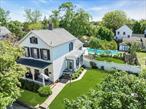 This stately 3 bedroom, two bath Greenport Village home, with an inground pool and beautifully renovated kitchen and baths, is handsomely set on a nice size lot. The charming front porch, large back deck leading to the gardens, and extensive decking surrounding the swimming pool add both curb appeal as well as outdoor living enjoyment. Lovely interior details, including just-refinished wood floors, mingle with sleek updates to create an exquisite living space. Village shops, restaurants, public transportation, and the 5th Street Beach are all close by. A lovely place to call your own in the delightful seaport Village of Greenport!