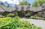 An Enchanting Stone Manor-First Time Offered. Set amidst exquisitely landscaped grounds in the heart of the Hudson Valley, this extraordinary stone manor is a triumph of design, craftsmanship, and settingâ€”gracefully secluded, yet just minutes from the bucolic village of Millbrook. Meticulously conceived and built to the highest standards, the estate is being offered for the very first time.Approached via a private drive and framed by blooming perennials and mature ornamental trees, the residence exudes timeless elegance. Inside, a welcoming foyer opens to a soaring great room, where floor-to-ceiling windows bathe the space in natural light and frame captivating views of the landscape beyond.The flowing floor plan encourages effortless living and entertaining: a formal dining area seamlessly adjoins the great room, while a chefâ€™s kitchenâ€”expansive and beautifully appointedâ€”offers space to gather, create, and celebrate. A walk-in pantry, laundry suite, and mudroom connect to the three-car garage, ensuring discreet everyday functionality.Adjoining the kitchen, the relaxed and inviting family room centers around a classic wood-burning fireplace, leading to a sunlit conservatory wrapped in glass, where tranquil views of a spring-fed pond and rolling lawn unfoldâ€”a sanctuary in every season.The main level features a flexible bedroom suiteâ€”ideal as a primary suite or luxurious guest quartersâ€”alongside a second bedroom and a stately home office. Upstairs, a sprawling primary suite serves as a true retreat, complete with an elegant bath, a massive custom walk-in closet, and an additional space perfect for a studio, craft room, or dressing lounge.Beyond the main residence, an extraordinary party barn offers limitless versatilityâ€”host grand events, showcase a car collection, or create a sport court or gallery space. Below, a bespoke winemaking facility includes a climate-controlled, glass-enclosed cellar designed for aging and displaying a curated collection.Perfectly positioned with convenient access to dining, hiking and biking trails, the Taconic State Parkway, and Metro-North rail, this estate offers an exceptional lifestyle amid the timeless beauty of the Hudson Valley.