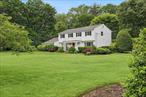 Located in the Incorporated Village of Muttontown and within the Syosset School District, this updated Center Hall Colonial sits on a flat, private 1-acre lot. Featuring 5 bedrooms and 3.5 baths, the home offers hardwood floors throughout and a spacious, functional layout. The gourmet eat-in kitchen is equipped with top-of-the-line stainless steel appliances and opens to a large great room with a wood-burning fireplace. Formal living and dining rooms offer great natural light. The first floor also includes a bedroom, full bath, powder room, and mudroom with laundry.Upstairs, the primary suite features a walk-in closet, dressing area, and updated bath with radiant flooring. Three additional bedrooms and a renovated full bath complete the second level. The recently renovated basement offers ample storage and houses all utilities, providing both functionality and extra space. Outdoor highlights include a heated in-ground pool, hot tub, sundeck, firepit area, and a fully fenced yard with mature landscaping. Additional features: central air, two-car garage, and oversized driveway. Convenient to train, shopping, schools, and highways. Zoned for Berry Hill Elementary and South Woods Middle.