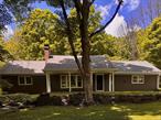 This is the loveliest country home you&rsquo;ll find! The beautiful 3-acre lot is a picture-perfect fresh air delight. No neighbors behind you with about 250 acres of undeveloped woods, rolling hills, and wildlife. No neighbors in front of you either, just a babbling stream that sings to your delight as you side on your just re-done front porch. Wide yards and mature trees surround the house&rsquo;s front, sides, and back. Of course, the extra-long deck can accommodate all friends and family that will be visiting. When you are inside, sunshine and nature are framed peacefully in the oversized windows. The kitchen is well equipped for any chef! A 6-burner stainless steel stove with outside exhaust, a new stainless steel Frigidaire Galley refrigerator, and updated cabinetry are yours for the asking! The living room hosts the brick-front wood-burning fireplace for the chilly days and nights ahead, and wide plank refinished hardwood floors. Two - 1st floor bedrooms with hardwood floors, a laundry room, and a full bathroom make it easy for 1-level living. The 2nd floor is one gigantic room with a full bathroom, oversized windows, and access to the unfinished (and huge) walk-in attic.