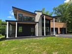 Experience the Epitome of Modern Luxury LivingNo detail has been overlooked in this exceptional smart home, where premium quality and sophisticated design are evident throughout â€” down to the solid wood interior doors. This 4000 sq ft residence features 2, 308 sq ft of versatile living space, including a spacious unfinished walkout basement that presents an exceptional opportunity for customization. Envision the possibilities for a dedicated theater room, additional bedrooms, or any other luxurious amenities you desire, making it a perfect canvas for elevated living. Situated on 4.1 private acres just 8 minutes from the charming Village of Goshen, this ultra-modern residence offers the perfect blend of comfort, style, and cutting-edge technology.This thoughtfully designed home features 3 spacious bedrooms and 3 beautifully appointed bathrooms. The open-concept kitchen is a chefâ€™s dream, showcasing stunning quartz countertops, a large island perfect for entertaining, and seamless flow into the living and dining areas.Bifold glass doors lead to a generous rear deck, creating a harmonious indoor-outdoor living experience. The luxurious primary suite includes dual walk-in closets, a double floating vanity, and a spa-inspired tiled shower. Two sliding doors open onto a private rooftop deck â€” a serene escape offering both tranquility and elegance.This smart home is equipped with Wi-Fiâ€“enabled appliances, a comprehensive security system, and programmable outdoor lighting that can be customized to celebrate every season or occasion.Additionally, the property is approved for a secondary dwelling, which can accommodate up to three bedrooms and one bathroom â€” an excellent opportunity for a guest house, rental unit, or extended family suite.