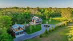 Welcome to this exceptional custom-built home nestled on 1.1 secluded acres, offering the perfect blend of luxury, comfort and privacy. Hidden at the end of a long driveway, the main house boasts 3 bedrooms and 3.5 bathrooms. The 1st floor main suite features include double doors that open to a private deck, a WIC and an expansive master bathroom equipped with a spa style rain shower. To add to the resort feel, the house is equipped with radiant flooring in all rooms and levels, a two story great room with an indoor/outdoor stone fireplace and a Chef&rsquo;s kitchen with custom-built cabinetry and granite counters. Large sliding doors lead you onto a wrap-around, mahogany deck with views of greenery and a stunning gunite pool. Upon leaving the main house, you will find every car lover&rsquo;s dream. A large barn style 4-car garage with ample height for additional car lifts. The 2nd floor features a 1 BR, 1 Bath apartment, full kitchen and an open floor plan living room/dining room.