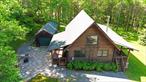 The Covered Wagon Cabin in Parksville, NY is the creme de la creme of upstate cabins. Set on 50+ acres this bonafide log home is everything you would expect when you envision an upstate getaway. The location is quiet, peaceful and private and a short drive to the highway for easy access. There are multiple garage and storage buildings for all the toys and atv&rsquo;s. The house itself is serious quality construction. The smell of cedar radiates throughout and a total of two bedrooms, full bath and open kitchen/dining/living room with wood burning stove on the main floor. The master with en suite bath in the upstairs loft PLUS a full finished basement with bunk room, game room, and full bath. There are no worries here with the back up generator, central air and the front porch overlooking the private yard and apple orchard. There is a nice stocked pond too with bass and giant catfish. This is a real dream place for the hunter or outdoor enthusiast with a house and property that can be thoroughly enjoyed by everyone.