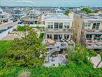 This stunning oceanfront retreat is perfectly positioned on the Atlantic, offering panoramic water views from private decks on all three levelsâ€”including a beachfront deck, a main-level terrace, and an exclusive balcony off the luxurious primary suite. The primary suite features a cozy fireplace and a brand-new spa-inspired bathroom with radiant heated floors. With four spacious bedrooms and the potential to add a sixth, thereâ€™s ample room for family and guests.The expansive, sun-drenched open-concept living and dining area includes a second fireplace, creating an inviting space to relax or entertain. The modern kitchen is beautifully updated with sleek quartz countertops, stainless steel appliances, and contemporary cabinetry.Located in Long Beachâ€™s vibrant West End, just steps from the sand and within walking distance to the areaâ€™s top restaurants, cafes, and boutiquesâ€”this is coastal living at its finest.