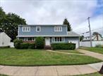WELCOME to this five bedroom two full and one half bath Colonial style home located in the highly desirable Syosset area/school district and centrally located to major highways, stores, restaurants and train station. On the main floor youâ€™ll find two bedrooms, a living room, dining area, kitchen and a full bath. The living room, dining room and hallway have hard wood floors. The kitchen flooring was updated in November 2021. The second floor, features primary bedroom, two additional bedrooms, a full bath, laundry room and additional room that can be used as an office. The home has a front porch, one car attached garage, a nice-sized private back yard with vinyl fencing and an unfinished basement with a 1/ 2 bath presents an opportunity for additional living space. The driveway is cut for a 2nd driveway allowing to build a 2-car garage and expand the 2nd floor for additional living space. Rented solar panels helps reduce your electric bill. Sprinkler system helps maintain the yard.