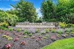 Encore Lake Grove is a luxury 55+ active lifestyle condominium community. This unit is a very unique, custom upper unit Bach in a cul-de-sac. Enter on the lower level and take the stairs or your private elevator up to the unit. Not only does this Bach have a loft with built-ins suitable for office/crafts/additional guest space, it also has an additional room on the main level which would suit any variety of uses. The eat-in kitchen has crown molding, beautiful wood cabinetry, large windows, stainless appliances. Your private balcony , accessible from the kitchen and the living room, private balcony has an expansive view of green lawns and plantings. The large dining room with crown molding leads into a bright living room with cathedral ceiling and fireplace. The large primary bedroom has an ensuite bath with dual vanity, built-in shower seat, and large spa-like tub. A second bedroom and full bath, and in-unit full-sized washer/dryer, complete the main floor. An added bonus for anyone with an electric or electric component vehicle - there is a charging outlet already in place!  Encore&rsquo;s beautiful clubhouse - a gathering place for many of the residents - boasts card rooms, billiard room, ballroom, exercise room, indoor heated saltwater pool, saunas, and many events and clubs. Outdoors are tennis and pickleball courts, putting green, bocce, shuffleboard, inground heated saltwater pool, ping pong, fireplace, barbeque, covered areas for relaxing and/or socializing, etc.. This is a gated community with a 24-hour manned gate house. Pets are allowed. Located across from Smithhaven Mall, Stony Brook Medical, Trader Joe&rsquo;s, Whole Foods, AMC Movie Theater, Lowe&rsquo;s, Marshall&rsquo;s. Wegman&rsquo;s, Costco, etc., and SO many restaurants. IT DOESN&rsquo;T GET BETTER, OR MORE CONVENIENT, THAN THIS!! One time initiation fee - $3000.00/ low annual Village tax -$309.36 (2025)
