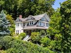 Gracefully perched on the Hudson, Riverstone Manor is a grand and beautifully restored estate now being offered â€”for the first time ever â€” with its enchanting companion, Holly Cottage, a guest house/artistâ€™s retreat that feels like it was lifted from the pages of a classic fairytale. The manor itself is nothing short of extraordinary. Built in 1901 in the traditional Arts and Crafts style, thoughtfully restored and meticulously maintained, the home features breathtaking Hudson River views from every room, a gracious and welcoming, wraparound porch with original stone columns, and original restored diamond windows. Riverstone Manor effortlessly blends historic splendor with convenient modern updates. Warm and inviting, the first floor features a parlor, dining room, two striking stone fireplaces, sweeping staircase, high ceilings, French doors to patio; well-appointed chefâ€™s kitchen with upscale appliances, butcher block island and soapstone counters; walk-in pantry; powder room and mudroom.The second level features a primary suite with a private river-view balcony, a zen-like study with gas fireplace andcustom bookshelves, a luxurious bath with twin pedestal sinks, convenient Miele washer/dryer, radiant heat floor and a spacious dressing room that can easily serve as an additional bedroom. Completing the second floor you will also find an additional bedroom and a full bath accented by custom tile and antique stained-glass. A secluded guest suite/writerâ€™s garret, on the third floor includes a spacious river-facing bedroom, a spa-like bath with shower enclosure and Jacuzzi soaking tub, and a marble kitchenette. The third-floor suite is perfect for visitors or extended stays. Plumbing/wiring updated during 2020 renovation/Pristine Hydro water filtration system/convenient central Vac, new furnace 2025. Perched high above the manor, Holly Cottage offers a whimsical and equally unforgettable counterpoint to the manor. With its storybook charm, stone patio and garden, commanding Hudson River views, complete privacy, and reliable rental history it presents not only a magical retreat but also a smart passive income opportunity. Ideal as a guest house, creative studio, or income-generating property, Holly Cottage is as versatile as it is enchanting. Together, Riverstone Manor and Holly Cottage offer a rare opportunity to own not just a home, but a piece of Hudson Valley history â€” in a timeless setting where grandeur meets grace.