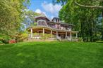 Nestled within the storied Red Spring Colony of Glen Cove, 110 Red Spring Lane is a masterfully restored Queen Anne Victorian that exudes timeless elegance and refined Gold Coast charm. Built in 1905 as part of a visionary enclave founded by Henry W. J. Bucknall, a prominent industrialist in the cork and linoleum trade this residence is a rare opportunity to own a true piece of Long Islandâ€™s Gilded Age history.Set on a private, landscaped acre, this grand home has been restored to its original splendor with great care and sensitivity to its architectural heritage. A sweeping mahogany wraparound porch beautifully updated welcomes you to a residence. Inside, the home features 4 spacious bedrooms, 2 full bathrooms, and 1 half bath. A thoughtfully designed kitchen with a breakfast bar offers functionality and warmth, ideal for both everyday living and elegant entertaining. Major updates completed between 2015â€“2016 include all windows, water heater, and HVACâ€”ensuring energy-efficient, worry-free living while preserving the home&rsquo;s historic integrity. Outside, the private grounds offer a serene oasis with an in-ground pool and seasonal water views, all situated in one of Glen Coveâ€™s most prestigious and historically rich communities. It is a rare architectural gem, a place where history, elegance, and modern luxury meet.