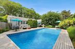 Welcome to 40 Maidstone Avenue, a beautifully renovated and expanded ranch located in the heart of East Hampton Village. This turnkey home offers approximately 2, 000 +/- square feet of living space with 3 spacious bedrooms and 2 full bathrooms. Inside, the layout features two separate living rooms-ideal for entertaining, relaxing, or creating a flexible work-from-home setup. Hardwood floors run throughout, and the main living room is anchored by a wood-burning fireplace. The updated kitchen offers modern finishes and functionality, perfect for everyday living and hosting. Central air conditioning ensures year-round comfort, and a full, unfinished basement provides potential for additional living space or storage. Step outside to a private, fenced backyard with a resort-style setting, including a sparkling in-ground pool-ideal for summer relaxation or entertaining guests. The home sits on a generous 0.23-acre lot with mature landscaping. Located just minutes from shops, dining, transportation, and ocean beaches, 40 Maidstone Avenue offers the best of East Hampton Village living in a prime location.