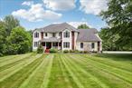 This beautiful home sits on 7.3 acres at the end of a cul-de-sac. Property is partially wooded and runs in back to a stream. The eat in kitchen has a nook with window seat and sliders to the deck. Kitchen has granite countertops and pantry. Door goes out to the 2 car garage. The formal dining room opens to the foyer which steps down to the stunning living room. It is two stories high, with a stone fireplace and large windows. Also on the first floor is an office/studio, full bath and a large auxiliary room with double doors. This would make a great study, tv/game room, etc. Upstairs is an open walkway overlooking the living room. At one end of the walkway are two bedrooms and full bath. At the other end is the primary suite. Bedroom with door to deck, a full bathroom and walk in closet. There is also a laundry room and the fourth bedroom, which is currently being used as a dressing room. The basement is full, unfinished and walks out on grade to the patio. There is an above ground pool in the back yard, tucked into a terraced area with deck. Property is beautiful, with a front lawn that sweeps up to the cul-de-sac. Wide side yards and huge back yard, partially wooded. This is a must see!