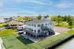 Welcome to 200 Clocks, a rare waterfront opportunity offering 200 feet of bulkhead and boat slips on three sides, just minutes from Breezy Point Park and the open bay. Set on 1.8 acres, this parcel includes a stunning 3, 710 sq ft modern luxury home and approved subdivision plans for two lotsâ€”ready to be finalized at buyerâ€™s request, if desired.The 3-bedroom, 3.5-bath home was raised and completely rebuilt in 2017 and is the ideal setup for year-round living, a summer getaway, full-season rental, or high-yield short-term rental investment. Each bedroom has its own private, spa-like bathroom, and the open-concept living space features a large kitchen island, solid-surface counters, and sleek tile floors throughout. The layout is perfect for entertaining, with areas staged as a game room, living room, dining space, and home gymâ€”all with views of the canal and surrounding water.The home is fully furnished, move-in ready, and positioned to generate income immediately. Enjoy a boater&rsquo;s dream lifestyle with bulkhead and dockage, access to nearby yacht clubs, and the ability to boat or drive to waterfront dining.Whether you&rsquo;re an end user looking for a luxurious escape or an investor exploring income potential or development options, this is an unmatched opportunity. Purchase as one expansive estate or explore options to buy Lot A (home + 1.02 acre) or Lot B (vacant .66 acre).