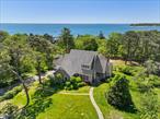.85 AC Hilltop Sanctuary, Pool, Bay Views and Private Beach Access! Welcome to Sunrise Terrace where nature and privacy abound at this hilltop sanctuary property, offered for sale for the first time. This former artist&rsquo;s home is architect designed and offers and elegant floorplan, offering space and privacy for family and guests. Enter from the covered front porch to the foyer that opens to a kitchen and breakfast area, large family room with fireplace, south facing windows that look out to the rear yard and pool area, and French doors to the outside deck where you can enjoy sunshine and bay views. Flow into the formal living room with a second fireplace and more south facing windows allowing for all day sunshine and French doors to the deck. There is a formal dining room for gathering with family and friends. Two guest bedrooms and full bath as well as hardwood floors throughout make up the first floor. Upstairs the primary suite offers a space that could be a sitting area, office or art studio, large bedroom space with bay views, two walk in closets and a bath with extra room for expansion if desired. There is a full lower-level walkout with a full bathroom, workshop space and doorway for easy access. In addition, the two-car detached garage is an excellent space for car storage or converting to a pool house or art studio. Outside, enjoy the new deck which faces south and offers all day sunshine and views of Shinnecock Bay and the expansive rear yard and pool all fenced in for privacy and security. The pool is surrounded by decking for sun lounging and gardens for enjoyment. This lovely property is situated in an established neighborhood and has private Shinnecock Bay beach access at the Sunrise Terrace Beach Club, located a block away, great for beach walks, shell collecting, swimming and all water sports. Minutes to ocean beaches, Southampton and Hampton Bays villages for shopping and great restaurants. Hurry...this one won&rsquo;t last!