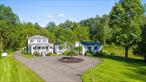 Set on nearly 20 secluded acres, this thoughtfully designed home is just minutes from the vibrant centers of New Paltz, Rosendale, and Stone Ridge. With proximity to the Mohonk Preserve and the natural beauty of the Wallkill River, the location balances total privacy with easy access to the best of the Hudson Valley.The home welcomes you with a gracious, light-filled foyer and multiple living spaces designed for both comfort and entertaining. The open-concept kitchen, dining, and living area flows seamlesslyâ€”ideal for gatherings large or small. A custom coffee station and cocktail bar elevate everyday living, while an expansive recreation room with a sunken indoor hot tub offers a relaxed, multifunctional space for leisure and entertaining.The main-level primary suite is a quiet retreat, complete with its own half bath and private access to the rear deck. A nearby room provides flexibility for a guest suite or dedicated home office. The level is rounded out by a full bath and a spacious laundry and pantry area for practical convenience.Upstairs, two additional bedrooms offer serene views of the surrounding landscape and share a well-appointed full bath with updated finishes.Outdoor living is where the property truly shines. A luxurious saltwater poolâ€”recently upgraded with a new liner and filterâ€”anchors the multi-tiered outdoor spaces, which include a wraparound deck, grilling and dining areas, and a custom-built fire pit set on a manicured front lawn. The grounds are further enhanced by a tranquil stream that meanders through the rear of the property, leading to the Wallkill River frontage beyond.Two detached garage structures provide ample space for vehicles, storage, or workshop use. Additional features include a whole-house generator, professionally installed high-speed internet and cable, and a circular driveway that enhances the estateâ€™s welcoming approach.Whether youâ€™re seeking a full-time residence, a weekend escape, or an investment-grade retreat, this meticulously maintained property offers a rare blend of scale, design, and location in one of the Hudson Valleyâ€™s most desirable regions.