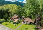 This beautiful estate must be seen. Owned by the same family for over 40 years, the compound has been lovingly expanded and restored. It is anchored by an 1870 farmhouse with many amenities. You enter the house to a wonderful chef&rsquo;s kitchen with cathedral ceilings accompanied by a walk-in pantry. There are granite countertops and top appliances. The first floor includes a spacious entertaining room and family room with a gas fireplace, as well as an en-suite bedroom and bath. The en-suite bedroom has a heated porch which leads to an outdoor deck. There are five different hardwoods used for the floors and three different hardwoods in the ceilings creating a unique style for each room. The sauna is also centrally located on the first floor. The second floor houses three bedrooms and a full bath. The third floor bedroom opens to its own balcony. Throughout the house are hardwood doors, French doors and multiple skylights. As you exit the house you come to the state of the art recording studio. It includes a full kitchen, full bath and an upstairs sitting lounge. This building can be easily converted to an additional living unit which matches the motif of the home. Leaving the studio you reach a free standing small home office. The next building houses two one-bedroom apartments, a four bay garage and a full workshop. You now reach the piece de resistance, a 20 by 40 foot in ground pool with heated pool house and changing room. The expansive gardens contain a storage cabin with an attached sitting deck offering expansive mountain views. Across Plank Road is an additional .6 acre parcel, included in this sale, providing private access to the Esopus Creek. Located just five minutes from Phoenicia, it is twenty minutes to Woodstock and a half hour to Kingston as well as both Bellayre and Hunter Mountains. You have the advantage of the nearby Ashokan Rail Trail offering year-round hiking and biking, as well as just enjoying one the country&rsquo;s most beautiful settings. It is also proximate to the Zen Mountain Monastery. If you are looking for a luxurious family compound, providing country living, please take advantage of this unique opportunity. We are also offering the property as a commercial recording studio with both the studio and home fully furnished and equipped.