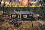 Lake View Hideaway-Introducing 34 Overlook Road, a renovated and charming house overlooking Lake Paradise. The house is set back off the road and situated amongst the trees which provides privacy and a tranquil ambiance. The wide plank barnwood flooring, wood-burning fireplace, and sliding barn doors all contribute to the laid-back farmhouse vibe. The house is currently a successful year-round Airbnb. This is a great opportunity to purchase a lovely full-time home, vacation house, or short-term rental within the bounds of beautiful Catskill Park. Although it feels like a world away, itâ€™s under two hours from NYC.The house is in move-in condition, with recent upgrades including a new roof, renovated bathrooms, and a re-sealed deck. The main level features a spacious living room accentuated by a floor-to-ceiling brick fireplace. The dining area is large enough to fit a table for 10+. The large chefâ€™s kitchen offers butcherblock countertops, stainless-steel appliances, an island with a breakfast bar, farmhouse sink, and a delightful splash of color with blue cabinets and a pantry. The primary bedroom is very spacious and has sliding barn doors that lead into the living room. It also has a balcony with lake and mountain views. There is one more bedroom on this level, as well as a large and fully tiled bathroom with a bathtub.The lower level is mostly finished and can be accessed by a spiral staircase on the interior or through multiple doors from the deck. At the bottom of the staircase is a recreation room which is currently set up with two beds but can be used as a family room or game room. There is a large bedroom with a stylish bed nook, a door to the side deck, and a sitting area with a pellet stove. An additional guest room provides even more flexible space and has access to the back deck, as well as a utility room with laundry and storage. A second full bathroom is located between the three rooms.The exterior grounds provide ample space for enjoyable outdoor recreation. Relax and entertain on the oversized, wraparound deck while enjoying views of the mountains and lake. Kick back on a hammock, throw some steaks on the grill, or catch some rays of sun through the trees, all while breathing in the clean mountain air. Enjoy some quality time with family and friends around the firepit and make memories that will last a lifetime.Perched in the serene hills of Neversink above Lake Paradise, this house is the perfect getaway from the hustle & bustle of city life. Both the Neversink & Rondout Reservoirs are nearby, offering excellent fishing, boating and bird watching. Nature abounds in the nearby Willowemoc Wild Forest, Sundown Wild Forest, Peekamoose Blue Hole, Little Beaver Kill & Willowemoc Creek. The Neversink Deli & General Store is 5 minutes away, offering a delicious menu and convenient shopping.The house can be sold fully furnished, for a truly turn-key, Airbnb ready, sale. Come see it today!