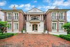 Welcome to this beautifully built Center Hall Colonial in the heart of Jamaica Estates. Set on a generous 102x81 lot (9, 020 sq ft), this custom-designed home offers timeless architecture, thoughtful layout, and quality finishes throughout. With heated floors and soaring ceilings on every level, the home combines classic comfort with modern luxury.The main floor features a sunlit living room with a stately fireplace, a formal dining room with its own fireplace and detailed wainscoting, a cozy family room, and an oversized eat-in kitchen outfitted with Thermador appliances, custom cabinetry, and polished stone countertops. A stylish powder room completes the space. Upstairs, the primary suite includes a fireplace, a large walk-in closet, and a spa-style bathroom with soaking tub and walk-in shower. Three additional en-suite bedrooms offer privacy and terrace access through elegant French doors that open to charming private balconies. The third floor provides even more flexibility with a large bedroom and two full bathroomsâ€”ideal for guests, extended family, or work-from-home needs. The basement is its own retreat, featuring exceptionally high ceilings, a spacious family room with fireplace, an entertainerâ€™s wet bar, a fully equipped home gym, and a complete laundry room with built-in cabinetry. Also on this level is a full indoor spa suite, including a swimming pool, hot tub, sauna, and private changing rooms designed with the feel of a luxury locker room. This home offers the ideal blend of traditional design and modern amenitiesâ€”right in the heart of Jamaica Estates.