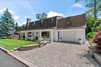 Welcome to one of the largest and most impeccably updated homes in Kings Park, located on the desirable North Shore of Long Island. Featuring four bedrooms plus an office/potential fifth bedroom, just minutes from scenic North Shore beaches, local shops, restaurants, and transportation, this stunning contemporary residence offers luxury, space, and sophistication on every level. Completely updated between 2013-2018 with top-of-the-line finishes, this home is a showcase of thoughtful design and exceptional craftsmanship. Skylights and expansive windows fill the home with natural light. The main level welcomes you with an entry foyer featuring a custom built-in barâ€”perfect for entertaining. You&rsquo;ll also find a spacious living room, elegant dining area, cozy lounge, sun-drenched sunroom with views of the yard, and a large gourmet kitchen. A full bathroom, convenient laundry area, and a luxurious primary ensuite complete this level. The primary suite boasts a stunning natural floor-to-ceiling stone gas fireplace, private deck with a hot tub, and spa-like amenities that offer a true retreat. Upstairs, youâ€™ll find three additional bedroomsâ€”one with a private side entranceâ€”three full bathrooms, two sitting areas, one which offers a second side entrance, additional laundry and a wet bar. This versatile layout offers the potential for a mother-daughter setup with proper permits. Step outside into your personal resort-style oasis: beautifully landscaped grounds surround an in-ground pool with pavers. A custom IPE Brazilian hardwood deck is crowned by a Shade Tree pergola with retractable drapes, creating the perfect space for outdoor dining and lounging. A conversation pit and in-ground sprinklers in the front and back complete the picture. Additional features include a Single-Layer Roof (12 y/o), Radiant Heat (8 zones), Front Pavers (10 y/o), and a copper mansard. TAXES W/ STAR $15, 890.71. This one-of-a-kind home combines luxury, location, and lifestyleâ€”donâ€™t miss the opportunity to make it yours.
