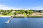 A Rare Waterfront Opportunity in the Heart of Bellport VillageNestled along the serene shores of Bellport Bay and just moments from the villageâ€™s charming downtown, this extraordinary offering presents over 3 acres of pristine, never-before-developed waterfront land. This is one of the most coveted parcels in all of Bellport Village.Bordering a protected natural preserve, the property boasts unrivaled privacy and panoramic elevated views of Bellport Bay, Fire Island and the Atlantic Ocean beyond. Set approximately 25 feet above sea level, the site provides the perfect vantage point for breathtaking sunrises, sea breezes and tranquil coastal living.A long, winding driveway leads you through a lush wooded approach, revealing the natural splendor and rare seclusion of this coastal sanctuary. The property includes substantial development rights, allowing for the creation of a world-class estate of up to 20, 000+ square feet. Envision a bespoke residence complete with luxury home, infinity-edge pool, tennis court, a four-car garage and more-designed to your exact specifications.With proper permitting for a dock, this will truly become a boaterâ€™s paradise. This is a once-in-a-lifetime opportunity to create a legacy estate in one of Long Islandâ€™s most sought-after enclaves.