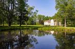 Historic Charm Meets Modern Comfort on 5 Bucolic Acres in Wallkill. Tucked away on a quiet country road, this exceptional c.1805 Greek Revival home seamlessly blends early American architecture with thoughtful updates and refined style. Set on 5 private, park-like acres, the property includes a heated gunite pool, a spring-fed pond with a small island, perennial gardens, and sweeping lawns bordered by stone walls and walkways. Inside the original 1800â€™s home, you&rsquo;ll find period details at every turnâ€”wide-plank pine floors, beamed and coffered ceilings, original hardware and leaded windows, and a Federal-style fireplace with a Dutch Delft tile surround and an original painted mural above painted in the 1930&rsquo;s of the neighboring Shawangunk Mountains. The spacious living room flows gracefully into the dining area and farmhouse-style kitchen, which features granite countertops, a wood-topped island, a cozy eat-in area. A ground-floor en-suite bedroom with a ceramic-tiled frameless glass walk-in shower offers convenient first-floor living. Upstairs in this original wing, you&rsquo;ll find two large bedrooms with vaulted ceilings that share a charming full bath with tub. A dramatic sunroom with a vaulted ceiling and stone fireplace connects the main house to a beautifully proportioned 1937 Colonial Revival addition. Here, you&rsquo;ll find rich, mahogany-colored paneling, custom built-ins, and a library-like ambiance anchored by a second wood-burning fireplace. Upstairs in this wing, there are two more bedrooms and another full bath, with a half-bath conveniently located on the main floor. In total, the property offers 5 bedrooms, 3.5 baths, and more than 3, 800 square feet of living space across two wingsâ€”ideal for guests, extended family, or a private office suite. The heated in-ground gunite pool sits quietly between the two wings, offering a private oasis surrounded by perennial flower beds and stone patios. Recent upgrades include new boilers, a buried electric line, a new roof (2016), and updated mechanicals throughout. Thereâ€™s also a fenced vegetable garden, invisible dog fencing, and a detached 2-car garage. Located just 90 minutes from NYC and minutes to Mohonk, the Shawangunk Ridge, Minnewaska State Park, the Shawangunk Wine Trail, and the vibrant towns of New Paltz and Gardiner, this rare homestead offers historic beauty, privacy, and convenience in equal measure.