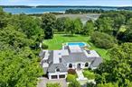 Escape to your own secluded sancturay where luxury meets nature&rsquo;s splendor. This extraordinary move-in-condition waterfront estate sprawls across 3.2 pristine, gated acres with exclusive private beach access on the most coveted and prestigous waterfron community of Centre Island- a hidden gen where tranquility and elegance converge. A French Chateau Masterpiece AwaitsStep through the grand foyer with soaring ceilings into this magnificent French Chateau style residence, where over 7, 000 square feet of sun-drenched living space captures breathtaking panoramic views of the Long Island Sound and bird sanctuary. Every window frames the glistening blue skies and water views.Luxurios Living Designed for Privacy & EntertainingThe main residence showcases 5 generously appointed bedrooms (including a convenient main-floor primary suite with stunning views of the pool and waterfront), 5.5 designer bathrooms, and a gourmet chef&rsquo;s kitchen that opens to formal dining spaces. The grand living room, adorned with floor-ceiling French doors, seamlessly flows onto an expansive terrace overlooking your sparling pool and endless blue waters beyond.For Ultimate flexibitlity, the lower level provides a completely private retreat with its own entrance-featuring two bedrooms, full bathroom, and an eat-in wet bar kitchen. Perfect for guest quarters, in-law suite, or extended family space, every room opens onto patios with stunning pool and waterfront vistas.Newly Reimagined Guest House Cottage; Your Personal RetreatThe brand -new completely renovated cottage blends timeless charn with contemporary luxury. This self contained haven features an open living area, sleek fully -equipped chef&rsquo;s kitchen, spacios bedroom with walk-in closet, and spa -like bathroom. Enjoy ultimate privacy on your personal terrace behind an impressive 18-foot architectural privacy wall, plus an additional patios perfect for sunset cocktails and barbeques. A dedicated private pathway and parking enusre complete indepence.Your Private Oasis in Nature&rsquo;s EmbraceThree fully-gated acres of meticously landscaped grounds provide the perfect sanctuary for pets to roam safely while you enjoy complete seclusion. The updated, fully -enclosed in-ground pool offers a tranquil setting with sweeping Long Island Sound views.Begin each day watching spectacular sunrises paint the sly, then unwinnd as golden sunsets cast their magic over Oyster Bay Harbor.Gateway to the the Gold Coast LifestyleCentre Island places you at the heart of Long Island&rsquo;s most coveted watrefront communities. Just minutes from the charming villages of Locust Valley, Bayville, and Oyster Bay, you&rsquo;ll discover pristine beaches, world -class restaurants, and vibrant boating culture. Whether you&rsquo;re sailing the Sound, dining waterside, or exploring quaint downtown streets lined with boutiques and cafes, the quintessential waterfront lifestyle awaits you.Seamless Elegance Meets Modern ConvenienceA gracious gated entrance welcomes guests via a circular driveway to your entrance. The Three-car garage and additional private parking ensure effortless entertaining. While classic architecture seamlessly integrates modern amenities througout. This rare waterfront estate offers the ultimate retreat for discrening buyers seeking privacy, luxury, and the authentic beach lover&rsquo;s lifestyle-all within an hour of New York City. A tru sanctuary where memories are made and dreams come to life.Not to missed-your private waterfront paradise awaits.