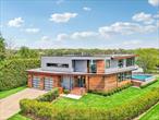 Sag Harbor Modern WaterfrontThis exquisite five-bedroom, five-and-a-half-bath residence, a creation by the esteemed Turkel Design, is meticulously crafted to leverage its prime location, offering breathtaking water views of Sag Harbor Cove from nearly every vantage point. A grand two-story foyer welcomes you into the open-concept living area, which seamlessly connects to the gourmet eat-in kitchen. This culinary space is appointed with marble waterfall countertops, bespoke cabinetry, a convenient butler&rsquo;s pantry, and top-of-the-line appliances, including dual Wolf wall ovens, a Subzero refrigerator, and a Bosch dishwasher. Floor-to-ceiling glass throughout the living areas captures expansive water vistas and provides direct access to the outdoor sanctuary. Your first floor also includes a Jr. primary with walk in closet, heated bathroom floors his home is replete with modern conveniences, including a 4-zone dual-hybrid heat pump propane furnace system, power window shades in the living and primary bedroom, a Ring camera system, pre-wiring for additional exterior video cameras, central vac, and a multizone irrigation system. Further enhancing its self-sufficiency are a 16kw solar panel system and a Generac 24kw generator. Practicality is key, with direct access from the garage to a generous laundry/mud room, and a powder bath. The attached two-car garage adds to the home&rsquo;s functionality. Upstairs, the primary bedroom suite offers an oversized walk-in closet, and a sleek freestanding tub set against a wall of glass, providing unparalleled views of Sag Harbor Cove. The second floor also hosts three additional en-suite bedrooms and a convenient second-floor laundry. The luxurious exterior features a free-form saltwater pool and spa, controlled by a Pentair system, all set within extensive teak decking. A charming wood-burning fireplace on the deck overlooks Sag Harbor Cove, complemented by indigenous landscaping, a new bulkhead, and dock. With direct water access, residents can easily explore the surrounding coves, bays, and waterfront restaurants on Shelter Island and the North Fork. This modern masterpiece presents an unparalleled opportunity to experience luxurious waterfront living in Sag Harbor.
