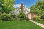 Welcome to this classic Tudor-style home, nestled on over half an acre in the desirable Gedney Farms neighborhood. This charming home seamlessly blends original architectural details with modern upgrades, caters to every lifestyle. The main level features a grand living room with a wood burning fireplace, a versatile den/office, formal dining room, and a delightful eat-in kitchen. A convenient first-floor bedroom with a full bath, powder room and a serene four-season with access to the outdoor deck room complete this level. On the second level, discover a spacious primary suite with a fully upgraded en-suite bath, 3 additional generous bedrooms, and a beautifully renovated full hall bath. Hardwood floors flow throughout, complementing the freshly painted interior and exterior. Enjoy outdoor living on the private deck, while the full basement with laundry and an attached two-car garage provide ample convenience. Prime White Plains location close to schools, golf, public transportation, and vibrant city amenities, . This home offers the perfect blend of luxury and convenience. Don&rsquo;t miss out!