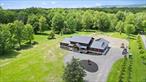 Step into refined modern living at 1248 Albany Post Rd in Gardiner, NYâ€”where design, sustainable innovation, and nature converge. This custom-built net-zero energy home offers over 3, 000+ square feet of beautifully designed space, blending cutting-edge technology with warm, natural finishes and sits on a peaceful 5-acre parcel, surrounded by the beauty of the Shawangunk Ridge. Every detail of this 3-bedroom, 3.5-bath home has been thoughtfully crafted. The striking exterior features a mix of stone and wood beneath a sleek standing seam metal roof, setting the tone for the sophisticated interiors. Inside, a soaring open-concept layout invites you in with warm wood-paneled ceilings, industrial-style exposed ductwork, and polished concrete radiant-heated floors that exude comfort and style. The gourmet open-concept kitchen is the heart of the home, with its custom cabinetry in a bold two-tone palette, premium appliances, and a large island perfect for gathering, it&rsquo;s designed for both function and style. An adjacent dining area and great room are flooded with natural light from walls of oversized windows, bringing the outdoors in and creating a seamless connection to the serene landscape. The great room is anchored by a modern custom-built floor to ceiling fireplaceâ€”ideal for everything from quiet mornings to lively evenings with guests. You&rsquo;ll find three spacious bedrooms and three-and-a-half baths, Each bedroom with an en-suite bath is a true retreat. The primary bedroom is spacious, with a walk-in closet and its own sliding glass doors to the back patio. The primary spa-like bathroom offers a luxurious retreat, featuring a soaking tub with woodland views, dual vanity, and high-end fixtures throughout. Each bedroom is spacious and designed with comfort and style in mind, with large windows framing tranquil views and thoughtful finishes that elevate everyday living. Outside, a heated ICF-constructed pool provides a perfect place to unwind or entertain, while the expansive property offers room to explore, garden, or simply enjoy the peaceful surroundings. The home is fully wired for smart technology, includes solar panels for true energy efficiency, and is even equipped with an EV chargerâ€”blending sustainability with top-tier modern living. The garage offers more than just a place to parkâ€”it was designed with intention and versatility. With concrete floors and custom-made tri-fold glass doors that glide open with ease, the space doubles beautifully as a playroom, media lounge, or additional family room. Whether you&rsquo;re entertaining, relaxing, or simply pulling in your car, it adapts effortlessly to your needs. Located just minutes from charming Gardiner village, world-class climbing and hiking in the Gunks, and the Mohonk Preserve, this is a rare opportunity to own a one-of-a-kind retreat that brings together form, function, in an unforgettable setting.