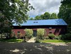 CONVERTED BARNS WITH POOL. This charming getaway offers fun lofty spaces to gather, entertain and enjoy the countryside, while conveniently located to the TSP and Millbrook Village. This 19th century converted barn was beautifully preserved and showcases the exposed beams and wide board floors. Upon entering, one is enamored by the soaring vaulted ceilings with exposed beams in the center of the home. A wall of glass in the living room seamlessly bridges the interior to the bluestone terrace outside. The bright country kitchen with whitewashed beams is complete with a fireplace. Offering 2, 820 square feet this home includes a music room and three bedrooms each with their own updated ensuite bath. Adding to the charm of this property is another converted barn used as a pool/guest house. Enjoy the summer by the heated saline pool in this peaceful setting.