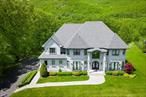 Magnificent Newly Built Custom Estate in the Heart of Pomona! This stunning estate sits gracefully on a quiet cul-de-sac, nestled on nearly 2 acres of private grounds overlooking the breathtaking Ramapo Mountains. Enjoy sweeping horizon views beyond the privacy of your lush, tree-lined oasis. Designed by renowned designers, this unique masterpiece embodies a bold modern elegance with a striking palette of black, gold, and white. The expansive residence features 8 bedrooms and 7 bathrooms. Enter through arched solid iron double doors into a grand black and white marble-floored foyer, crowned by 10-foot ceilings, intricate wall inlays, and a dramatic curved staircase with custom glass & gold railing spiraling upward beneath a jaw-dropping designer chandelier. The alluring living room captivates with detailed custom floor-to-ceiling upholstered seating, elegant black-framed French doors opening to a Juliet balcony, recessed lighting, and a sleek electric fireplace. Pella windows and custom square hi-hats flood the home in light throughout. Gather in the regal formal dining room, framed by matching French doors and Juliet balcony, beneath a sparkling tray ceiling adorned with color-changing ambient lighting that instantly shifts the mood for any event. A butlerâ€™s pantry with custom cabinetry, wine cooler, and sink enhances entertaining with ease. The sunken family room is a true showpiece with floor-to-ceiling windows offering panoramic views of the Ramapo Mountains and the expansive backyard. A stunning modern black and glass fireplace anchors the space beneath richly textured coffered ceilings, and luxurious custom black wood flooring that flows throughout. The chefâ€™s kitchen is intricately designed for the utmost convivence, while maintaining high-end modern style. Boasting a massive center island with tons of storage and breakfast bar with tucked seating. Additionally, equipped with quartzite Panta countertops, beautiful white tile backsplash, 3 custom gold-fixtured sinks, premium stainless-steel appliances, oversized refrigerator, pot filler, custom hood, 6-burner Wolf stove, an additional 2-burner top, 2 GE ovens, hidden walk-in pantry, 2 extra pantries, and lavish black cabinetry with gold accents. The dinette area offers stunning views through sliding glass door walk-out, leading to deck with large awning overlooking the back of this amazing property. Side-entrance mudroom with custom-built walk-in closet leads to private guest quarters featuring a full bath with luxury shower and kitchenette with personal mini fridge. The first floor is completed by a home office and sophisticated main bathroom. Upstairs holds 6 generously sized bedrooms featuring 9-foot ceilings, custom closets, and full custom window treatments. The primary suite showcases beautiful tray ceilings, custom walk-in closets, and a spa-inspired bathroom with a soaking tub offering mountain views, an oversized steam shower with bench, dual vanities, and exquisite crystal and gold finishes. A junior suite includes a private bath and walk-in closet, while two additional full baths service the remaining rooms, with the option to easily add a fifth bathroom upstairs. A convenient laundry room features built-in shelves and a laundry chute to a secondary washer and dryer on the lower level. Walk-out basement is partially finished and features high ceilings with a recreational room with lots of closest, an additional large bedroom, full bath, kitchenette, second washer & dryer, unfinished area for plenty of storage or customization, and private side entrance. Additional luxury features include radiant heating with a 10-zone system, central air conditioning (4 zones), central vacuum, and integrated surround sound throughout the entire first floor. A 4-camera security system, irrigation system, water softener, all house spray foamed insulation, 2-car garage along with a host of other high-end finishes complete this home. This one-of-a-kind residence is a rare find.