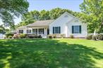 Located in a serene and secluded setting within the prestigious Great Rock Estates (NO HOA), this charming ranch offers the perfect blend of comfort, privacy, and neighborhood elegance. Located on a quiet street lined with Belgium block curbing, the picturesque surroundings set the tone for this well-maintained 3-bedroom, 2-bathroom home. Inside, you&rsquo;ll find a welcoming layout featuring a spacious living room with vaulted ceilings and a cozy den with a wood-burning fireplace. An open concept kitchen with skylight joins a formal dining area. The master bedroom includes a walk-in closet and an en-suite bathroom. The finished basement provides flexible space for recreation, a home gym, or a private office. Enjoy outdoor living on the covered front porch or in the expansive, beautifully landscaped yard with mature specimen trees and back deck, set on over half an acre. A one-car garage adds convenience and additional storage. This home offers peaceful seclusion in a sought after neighborhood while remaining close to local beaches, shops, restaurants, and North Fork wineries. Whether you&rsquo;re looking for a full-time residence or a seasonal home, this property delivers a lifestyle of comfort and charm.**Some photos have been digitally edited**
