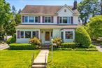 Offering nearly 3, 000 square feet of flexible living space, this distinctive Colonial sits on a quiet interior block less than 1/10th of a mile from the LIRR, Manhasset shops, and Northern Boulevard. The main level features a formal living room with a wood-burning fireplace and an adjacent open space that works beautifully as a den, playroom, or home office. The formal dining room flows into the kitchen, which offers workspace and potential for personalization. A south-facing enclosed porch overlooks the backyard. A unique first-floor wing includes a large bedroom with a walk-in closet and full bath, plus a family room with access from both the wing and the main part of the house. Ideal for guests, extended family, or work-from-home flexibility, this wing could potentially be fully integrated into the main layout if desired. Upstairs, the expansive primary suite includes soaring ceilings, a walk-in closet big enough to be a dressing room, and a large bathroom with jetted tub and separate shower. Two additional bedrooms and a full hall bath complete the second floor. A full staircase leads to a spacious, floored atticâ€”perfect for storage. The backyard is flat, private, and perfect for entertaining, relaxing, or play. Generous space, a flexible layout, and an unbeatable locationâ€”this home is a rare find in the heart of Manhasset.