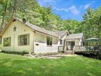 Discover serenity at this enchanting lakefront retreat on Mohican Lake. This property spans an impressive 7.93 acres, combining two parcels: 1.21 acres (SBL 3-E-1-15) hosting the charming home and 6.72 acres (SBL 3-E-1-17) of pristine land. The residence itself offers a bright and inviting open floor plan, featuring 3 bedrooms, 2 baths, and a cozy den perfect for relaxation or work-from-home needs. Outdoor living is a dream here, with a screened-in porch equipped with a ceiling fan and dining areaâ€”ideal for long, balmy summer evenings. A spacious deck overlooks the shimmering lake, while the patio area and fire pit provide the perfect setting for gatherings under the stars. A gentle path leads you to the lakefront, where you can unwind by the water or step onto your private dock to embark on jet skiing or boating adventures. The property also includes a generously-sized two-car garage with ample storage space, perfect for vehicles, recreational gear, or tools. Situated close to premier attractions such as Resorts World Casino, Kartrite Water Park, and Bethel Woods Performing Arts Center, this home also is close to the scenic Delaware River for kayaking and canoeing. All this is conveniently located just a two-hour drive from New York City. Please note that taxes cover both parcels. Embrace the tranquility and endless possibilities this lakefront gem has to offerâ€”a true haven for relaxation and outdoor enjoyment.