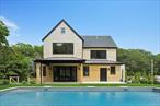 Beautiful Brand-New Coastal Barn-Style Retreat in Hampton Bays Welcome to 57 Newtown Road, where coastal modern elegance meets the timeless appeal of contemporary barn-style architecture. Perfectly positioned on a spacious 0.74-acre lot in the heart of Hampton Bays, this brand-new 2025 build offers 4 bedrooms, 3.5 bathrooms, and over 3, 600 square feet of meticulously designed living spaceâ€”including a 2, 690 SF main residence and a 913 SF finished walk-out basement.From the moment you arrive, the welcoming front porch and covered rear deck set the stage for year-round indoor-outdoor living. Inside, the home impresses with soaring ceilings, oversized Andersen 400 Series ENERGY STAR&#174; windows, and a bright, open-concept floor plan. Throughout the home, wide-plank white oak hardwood floors add warmth and character, while the designer kitchen features Avanti quartz countertops, stainless steel appliances, a dual-zone undercounter wine fridge, and sleek finishes ideal for both everyday living and entertaining.Upstairs, the thoughtfully designed layout includes generously sized bedrooms filled with natural light, along with well-appointed bathrooms throughout. The luxurious primary suite offers the ultimate retreat, with a large walk-in closet, a spa-like bath with dual vanities, and a large walk-in shower.Step outside to your own private backyard oasis complete with a heated pool, surrounded by elegant bluestone coping, curated landscaping, and a garden that rises to reveal seasonal water views from its high point. A 2-car garage with dual electric doors adds convenience and functionality.Additional Features & Energy-Efficient Upgrades Include:â€¢ Navien tankless hot water heaterâ€¢ Dual-zone central air & gas furnace HVAC systemâ€¢ Closed-cell spray foam insulation for superior thermal performanceâ€¢ Andersen Low-E windows for reduced heat transfer and UV protectionâ€¢ High-efficiency plumbing and mechanical systems throughoutLocated just minutes from beaches, bays, shopping, and dining, this exceptional home captures the very best of Hamptons livingâ€”offering a sophisticated yet relaxed lifestyle in a coveted coastal setting. This gorgeous home is the perfect year-round escape or summer haven!