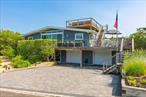 Nestled in the serene and sought-after Oak Beach Community, this stunning Mid-Century Modern home is a true coastal gem, offering a perfect blend of timeless design and luxurious updates. Boasting 4 spacious bedrooms and three beautifully updated bathrooms, the home thoughtfully designed for both comfort and style. At its heart is a gorgeous brand new kitchen, outfitted with custom cabinetry, high end appliances, granite countertops, a waterfall island and designer lighting - ideal for entertaining or everyday living. Spill into the beautiful living room where you can relax and unwind in front of a beautiful wood fireplace. The home&rsquo;s signature mid-century architecture features clean lines, vaulted ceilings and expansive windows that flood the space with natural light while framing beautiful barrier beach and natural landscape views. Step outside to the expansive wraparound deck, ideal for lounging, dining and soaking in the tranquil surroundings. And for the ultimate coastal experience, head up to the rooftop deck where you can enjoy spectacular sunrises and sunsets over the water on the Great South Bay extending to The Fire Island Inlet - a true paradise in every direction. With multiple living areas, updated systems, and a layout designed for effortless indoor-outdoor living, this Oak Beach retreat captures the essence of modern coastal living - just steps from the private beaches - yet tucked away in one of Long Island&rsquo;s most charming and exclusive beachfront enclaves.Gated/Private Community - please call agent for code