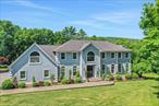 Beautiful custom built Colonial home located in a prestigious neighborhood of higher end luxury homes surrounded by privacy and nature at the end of a cul-de-sac. The rolling grounds offer professionally landscaped stone retained gardens, open living areas, children&rsquo;s playground, a pond, and distant mountain views. Enter the main foyer to a grand curved oak staircase and glistening wood floors. The elegant formal dining room is enhances with glass french doors, raised panel chair rail and a tray ceiling. The open and airy kitchen is loaded with crisp white cabinets, lots of counter space, a breakfast bar and eat-in area overlooking the deck. The second floor is comprised of 5 bedrooms, laundry room and another den. The grand master suite offers a walk-in closet, bath with double sinks, shower and deep soaking Jacuzzi style tub. Over the garage is the second floor den, this could be combined with the 5th bedroom for another master suite or in-law bedroom. Full attic is accessible by pull down stairs. Fully finished lower level creates another 1, 200 square feet of space, currently used as family and game room. This home has it all and located conveniently to the city of Kingston and five minutes from the NYS Thruway.