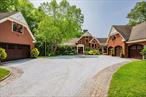 Grand post and beam home with level lake frontage and views, babbling brook, main level master suite, 9+ car garage, finished walk-out, and unfinished loft spaces for potential for expansion all set on 1.86 acres in a small gated community. Wide plank king&rsquo;s planking, exposed post and beam and cathedral ceilings in almost every room. Views from multiple rooms. Main level master suite with corner fireplace, walk-in closet, and attached full bath with soapstone flooring and surround. Eat-in-kitchen with Poggenpohl cabinets, stainless steel Viking appliances including 4 burner cooktop and griddle, double oven, and bev fridge. Breakfast nook overlooking the lake. 2 story great room rows of windows to capitalize on views and 2 story fireplace. Secondary bedroom suite also on main level. Dining room, office, laundry room, and powder room finish off main level. Upstairs separate loft with views. 3rd and 4th bedrooms upstairs with additional full bath. Lower level rec room with fireplace and walkout. Additional bedroom and full bath with separate lower level entry. Room for 9+ cars includes attached 3 car, detached 2 car, and detached 4 car garages. The 4 car garage has High bays that can accommodate lift, high doors, and an insulated and framed loft space. 2 car garage has a loft space and addition with access to plumbing and septic. Many possibilities for more living space. Whole home generator, dual 200 amp service, CAIR, radiant heat, irrigation, cameras, copper gutters, sec sys, driveway sensors. Too many extras to list! Heated salt water resistance swim spa with automatic cover. Gorgeous courtyard entry with belgian block and crushed stone. Dock for boat and jetskis. Excellent fishing! Bluestone patio and 2 gazebos fenced off with views! Absolutely stunning frontage is gradual and level at water.