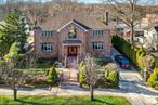 STUNNING ALL BRCIK COLONIAL MASTERPIECE SERENE SECTION OF BAYSIDESpectacular 5BR/5BA home on oversized 80x100 lot offering 3, 890 sq ft of luxury living plus full finished basement w/sep.ent. Dramatic grand foyer with soaring cathedral ceilings and chandelier welcomes you into sun-drenched living spaces featuring granite and wood floors throughout with custom millwork. Traditional Japanese style Tatami Washitsu room, granite kitchen with premium stainless appliances, eat-in area, and kitchen island flows seamlessly to the formal dining room. TWO granite primary suites with spa-like Kohler Jacuzzis provide ultimate relaxation. Cozy fireplace, central air, walk-up attic, 2-car garage. Botanical garden-style backyard oasis with ground level wood deck perfect for entertaining. Walk to Cunningham Park! Close to Alley Pond Golf Course and Nature Preserve. Premium location walking distance to top-rated PS 46 and JHS 74. Express buses to Manhattan. This is luxury suburban living at its finest!