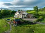 Welcome to Sunset Ridge Farm. A discreet tree-lined drive with expansive views of two aerated ponds and rolling hills leads to this breathtaking modern farmhouse estate. Set on 10 exquisitely manicured acres with mountain vistas, a heated in-ground pool, spa, and gardens reminiscent of the English countryside, 3585 Route 82 is a truly rare offering â€” a perfect full-time residence or refined weekend retreat.Designed by an award winning luxury hotelier and designer, every element of this 2022-built home reflects an extraordinary level of vision, craftsmanship, and artistry. Tasteful finishes, custom millwork, and hand-crafted cabinetry enrich the home&rsquo;s generous proportions and stunning open floor plan.An elegant entrance welcomes you into a gracious foyer and a grand living room anchored by a wood-burning fireplace, overlooking sweeping westerly sunset views over the foothills of the Catskills. Slide open the oversized doors to the pool area for seamless indoor-outdoor living at its finest.The chefâ€™s kitchen is a work of art, featuring a four-door Samsung refrigerator, Bertazzoni free-standing vintage range, steam and multi-wall ovens, a microwave, warming drawer, and an integrated hood set against a hand-made Zellige tile backsplash. The adjacent dining area features custom deVOL cabinetry and a full bar, creating a natural separation to a cozy office/den and a fitness room at the rear of the home.The luxurious first-floor primary suite wing enjoys spectacular sunset views and features a fireplace, dual walk-in closets, and a spa-inspired bathroom with inlaid marble floors, a deep freestanding tub, an oversized walk-in shower, and a state-of-the-art Toto toilet. Also on the first floor are a stylish deVOL-designed laundry room, a jewel box powder room, a mudroom, a two-car garage, and additional bonus spaces.Upstairs, three generous ensuite bedrooms, including a second luxurious primary, each feature walk-in closets and perfectly framed vistas. A media room, which doubles as a fifth bedroom, offers even more flexibility, complete with an adjacent full bathroom.The outdoor spaces are nothing short of spectacular, including a built-in outdoor kitchen with a BBQ and gas line hook-up, a bluestone patio, and multiple entertaining and lounging areas framed by French lavender gardens.A separate studio building with a kitchenette and bath provides a home office or an artistâ€™s retreat. Rounding out the estate are a full, dry basement with a temperature-controlled wine room, and a spacious walk-up attic with soaring ceilings, offering ultimate recreation and storage opportunities.Protected by surrounding majestic farmland yet located just moments from the Village of Millbrook, this turn-key modern farmhouse delivers an unparalleled lifestyle of quiet luxury, beauty, and timeless sophistication in the heart of the Hudson Valley.